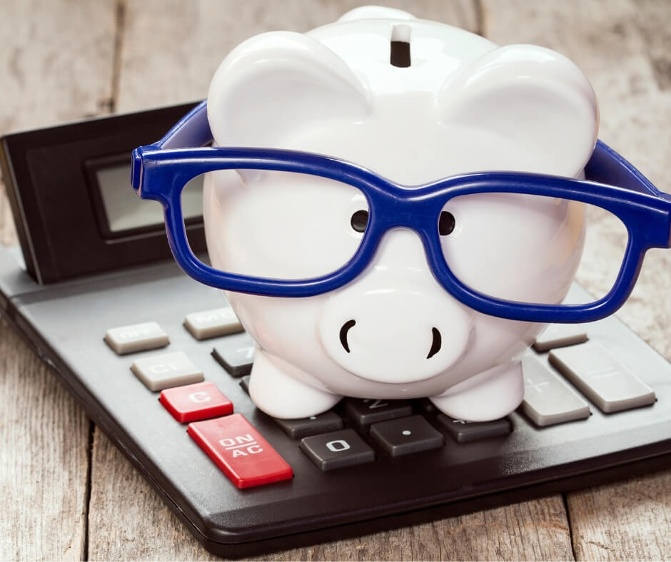 Piggy Bank with Glasses on Calculator Representing Amazon Reserve Funds