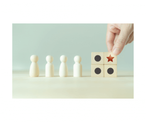 Hand positioning a red star block above other neutral blocks in front of figures, symbolizing niche market leadership on Amazon.